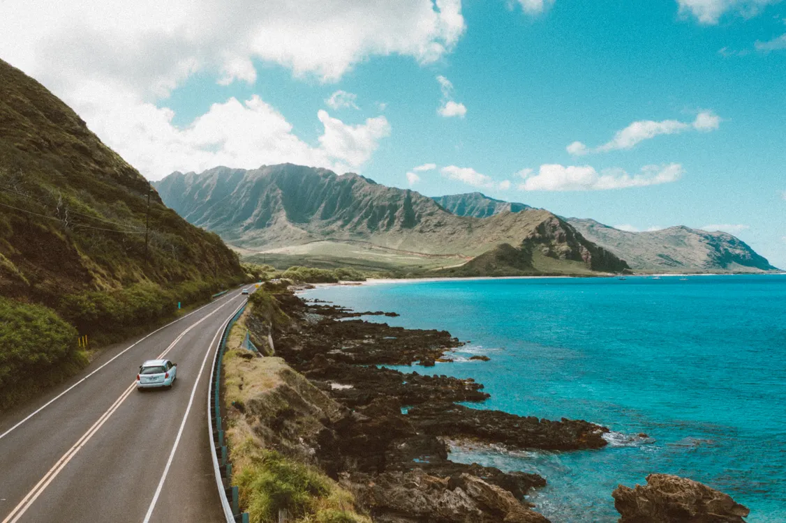 Car on a scenic road through a rocky landscape