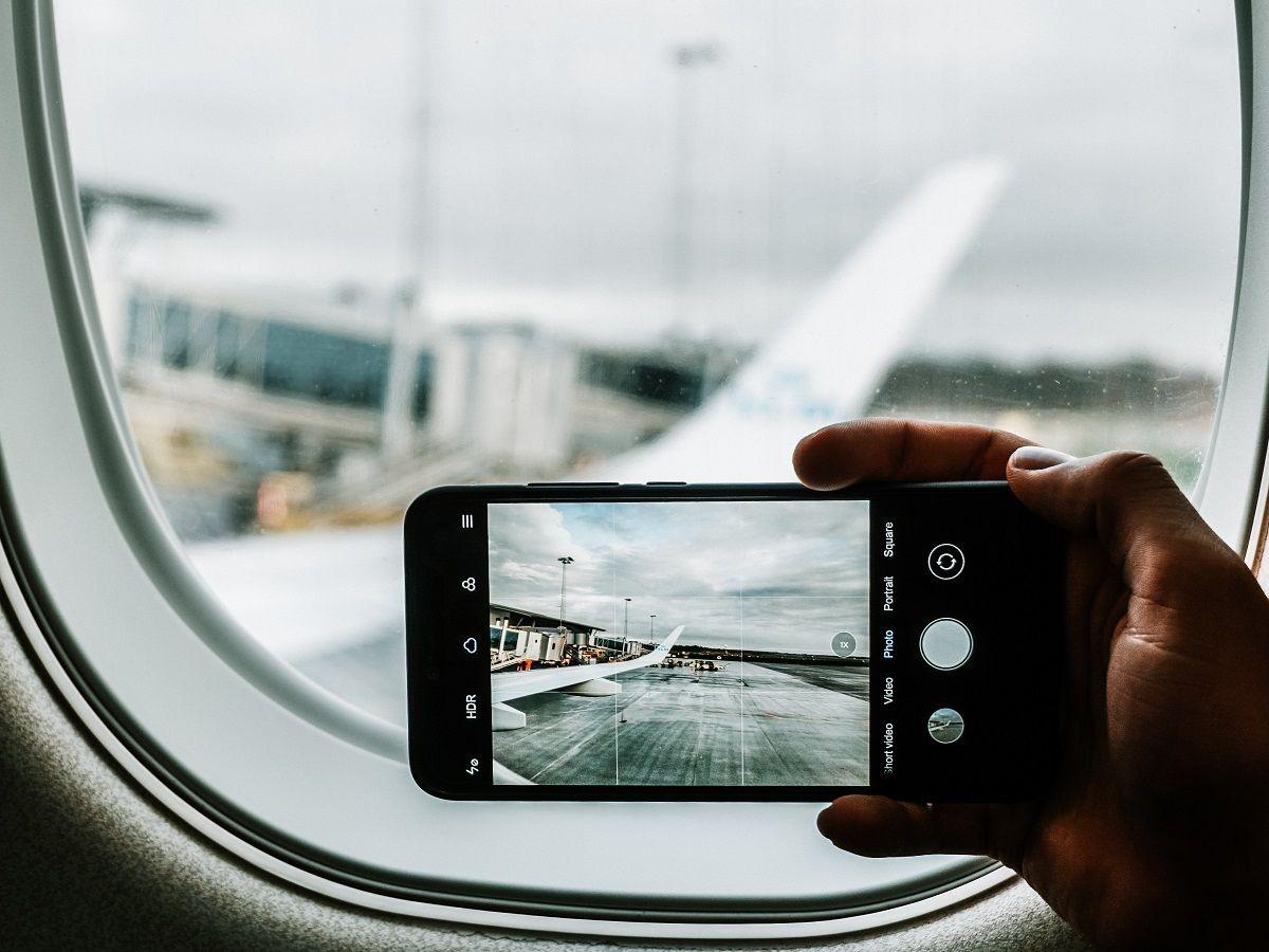 Traveler using a smartphone while waiting at an airport